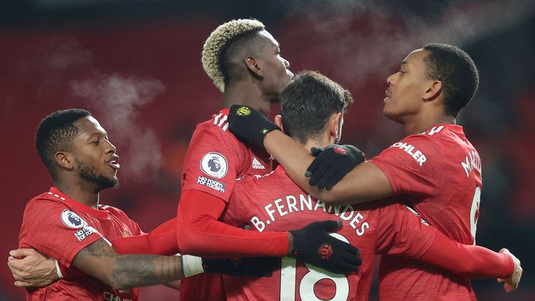 Manchester United&#39;s Bruno Fernandes, (18), celebrates with teammates after scoring his sides 2nd goal of the game from the penalty spot during the English Premier League soccer match between Manchester United and Aston Villa at Old Trafford in Manchester, England, Friday, Jan. 1, 2021