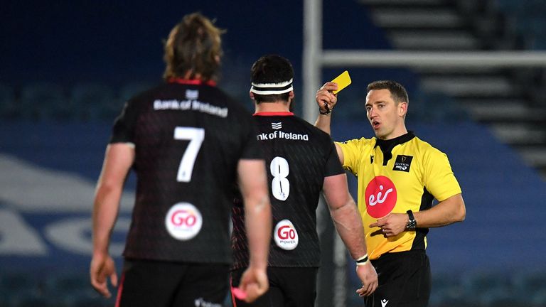 Referee Andrew Brace shows a yellow card to Marcell Coetzee