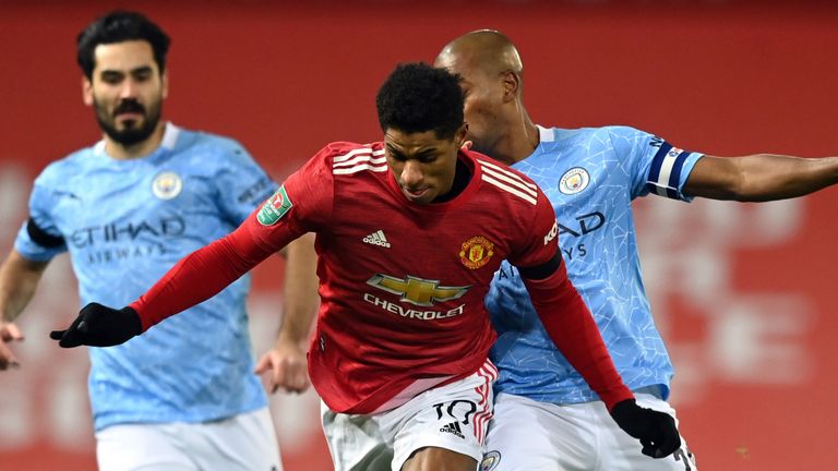 Marcus Rashford is challenged by Fernandinho