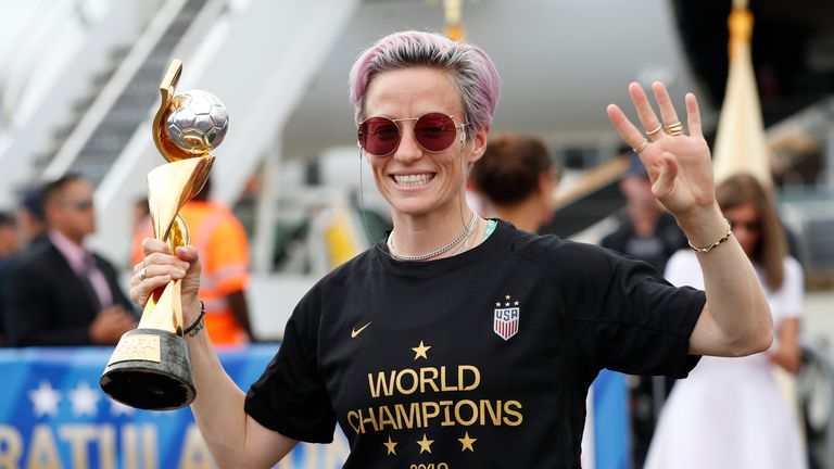 United States women's soccer team member Megan Rapinoe holds the Women's World Cup trophy as she celebrates in front of the media after arriving at Newark Liberty International Airport, Monday, July 8, 2019, in Newark, N.J