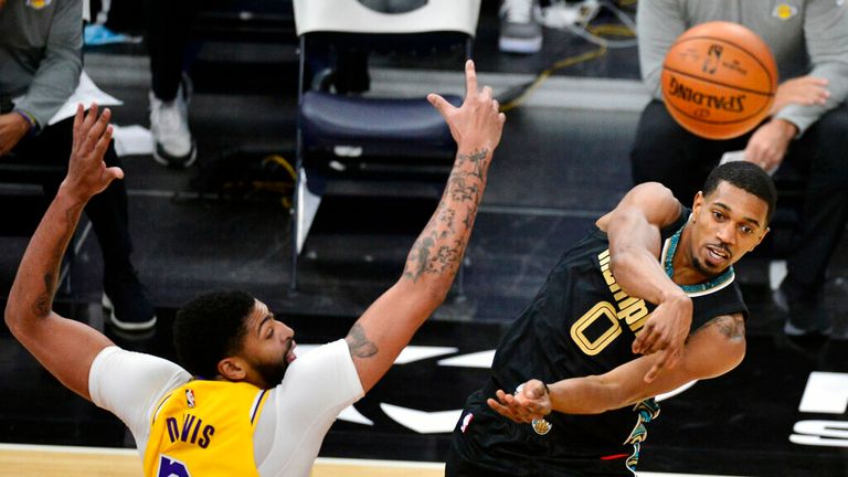 AP - Memphis Grizzlies guard De'Anthony Melton (0) passes the ball ahead of Los Angeles Lakers forward Anthony Davis (3)