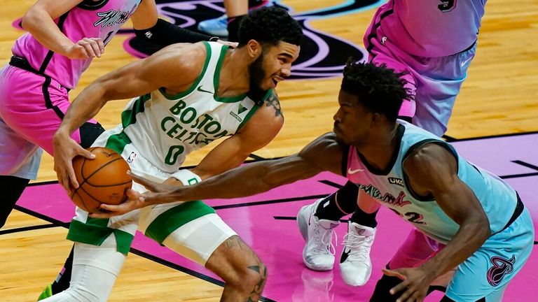 AP - Miami Heat forward Jimmy Butler (22) defends Boston Celtics forward Jayson Tatum (0)
