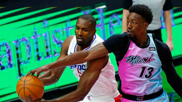 AP - Miami Heat center Bam Adebayo (13) and Los Angeles Clippers center Serge Ibaka (9) go after a rebound during the first half 