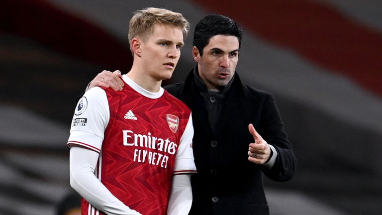 Mikel Arteta speaks to Martin Odegaard before he comes on as a substitute
