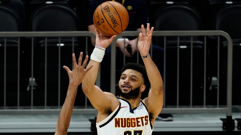 Denver Nuggets guard Jamal Murray shoots over Phoenix Suns forward Mikal Bridges (25) during the first half of an NBA basketball game Saturday, Jan. 23, 2021, in Phoenix.