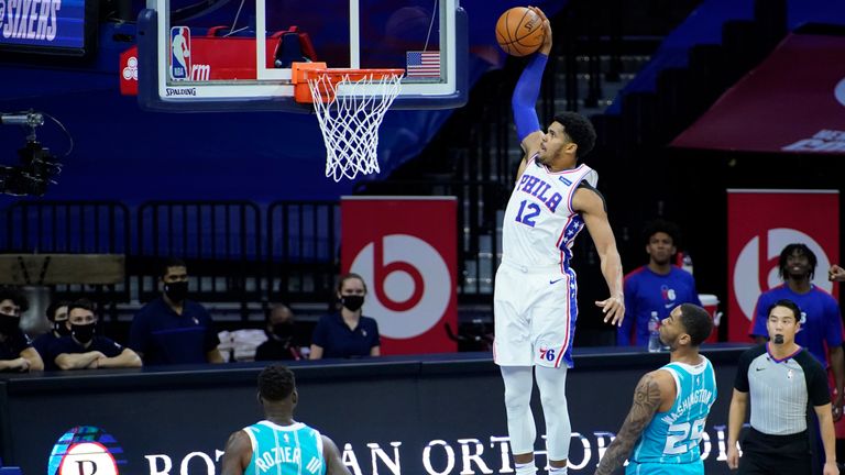 Philadelphia 76ers&#39; Tobias Harris (12) goes up for a dunk past Charlotte Hornets&#39; P.J. Washington (25) and Terry Rozier (3) during the first half of an NBA basketball game, Saturday, Jan. 2, 2021, in Philadelphia. (AP Photo/Matt Slocum)


