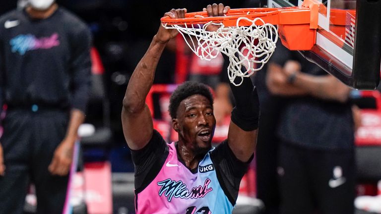 Miami Heat's Bam Adebayo (13) dunks in front of Brooklyn Nets' DeAndre Jordan (6) during the first half of an NBA basketball game Saturday, Jan. 23, 2021, in New York.