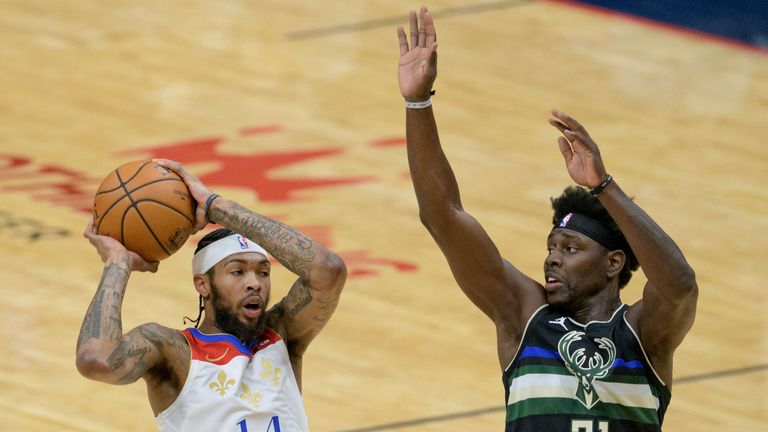 New Orleans Pelicans forward Brandon Ingram (14) shoots against Milwaukee Bucks guard Jrue Holiday (21) in the first half of an NBA basketball game in New Orleans, Friday, Jan. 29, 2021. (AP Photo/Matthew Hinton)



