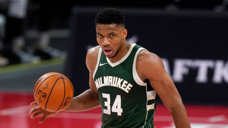Milwaukee Bucks forward Giannis Antetokounmpo brings the ball up court during the first half of an NBA basketball game against the Detroit Pistons, Wednesday, Jan. 13, 2021, in Detroit.