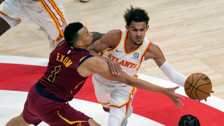 Atlanta Hawks guard Trae Young (11) is fouled by Cleveland Cavaliers guard Dante Exum (1) during the first half of an NBA basketball game on Saturday, Jan. 2, 2021 in Atlanta. (AP Photo/Ben Gray)


