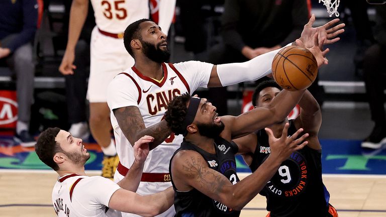 New York Knicks&#39; Mitchell Robinson (23) tries to grab the rebound next to Cleveland Cavaliers&#39; Andre Drummond (3) during the first quarter of an NBA basketball game Friday, Jan. 29, 2021, in New York. (Elsa/Pool Photo via AP)


