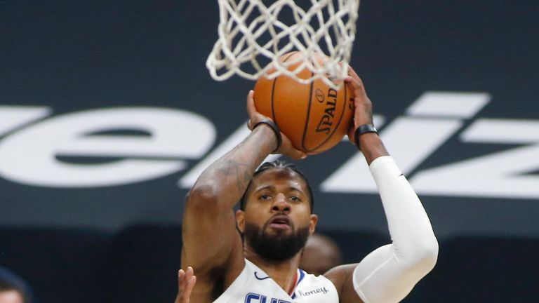 Los Angeles Clippers forward Paul George (13) shoots over the defense of Phoenix Suns guard Langston Galloway during the first half of an NBA basketball game Sunday, Jan. 3, 2021, in Phoenix. (AP Photo/Ralph Freso)


