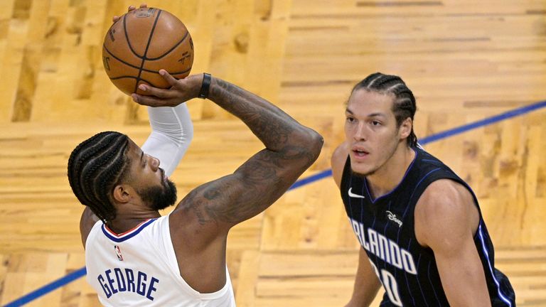 Los Angeles Clippers guard Paul George (13) goes up to shoot in front of Orlando Magic forward Aaron Gordon (00) during the first half of an NBA basketball game, Friday, Jan. 29, 2021, in Orlando, Fla. (AP Photo/Phelan M. Ebenhack)


