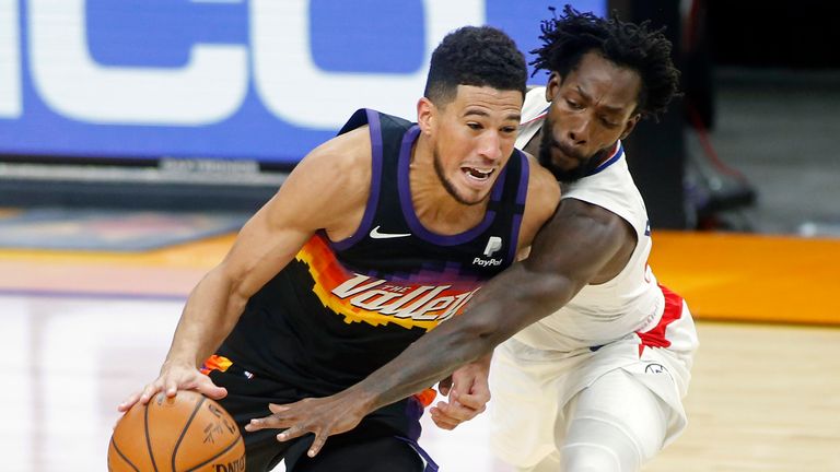 Phoenix Suns guard Devin Booker (1) drives as Los Angeles Clippers guard Patrick Beverley defends during the second half of an NBA basketball game Sunday, Jan. 3, 2021, in Phoenix. (AP Photo/Ralph Freso)


