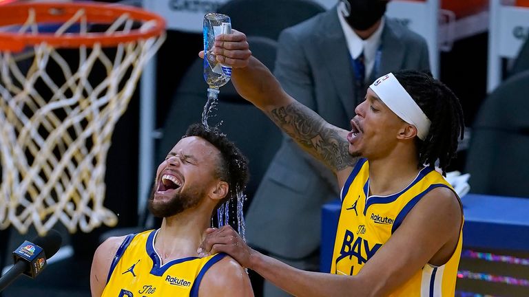 Golden State Warriors guard Damion Lee, right, pours water over the head of guard Stephen Curry (30) while celebrating Curry&#39;s career-high 62 points against the Portland Trail Blazers in an NBA basketball game in San Francisco, Sunday, Jan. 3, 2021. (AP Photo/Tony Avelar)


