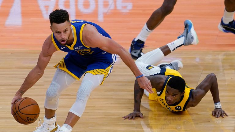 Golden State Warriors guard Stephen Curry, left, dribbles the ball in front of Indiana Pacers guard Edmond Sumner during the second half of an NBA basketball game in San Francisco, Tuesday, Jan. 12, 2021. (AP Photo/Jeff Chiu)


