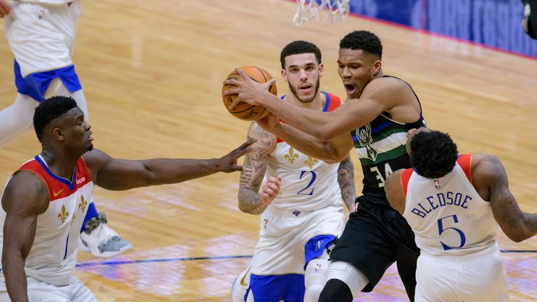 Milwaukee Bucks forward Giannis Antetokounmpo (34) shoots against New Orleans Pelicans guard Eric Bledsoe (5) and forward Zion Williamson (1) in the second half of an NBA basketball game in New Orleans, Friday, Jan. 29, 2021. (AP Photo/Matthew Hinton)



