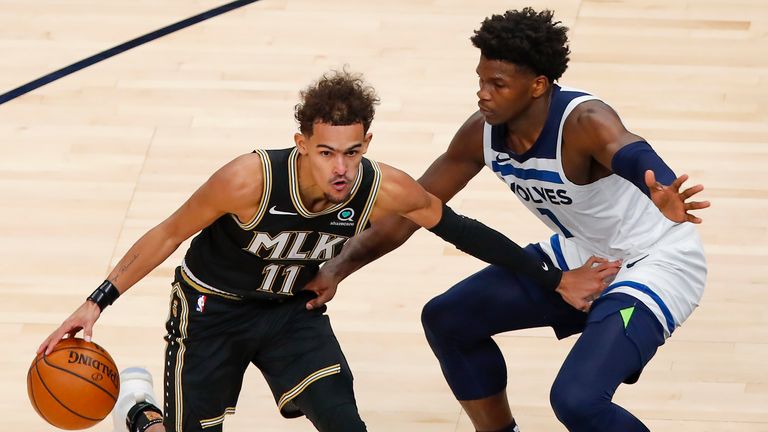 Atlanta Hawks guard Trae Young (11) battles Minnesota Timberwolves guard Anthony Edwards (1) in the second half of an NBA basketball game on Monday, Jan. 18, 2021, in Atlanta. (AP Photo/Todd Kirkland)


