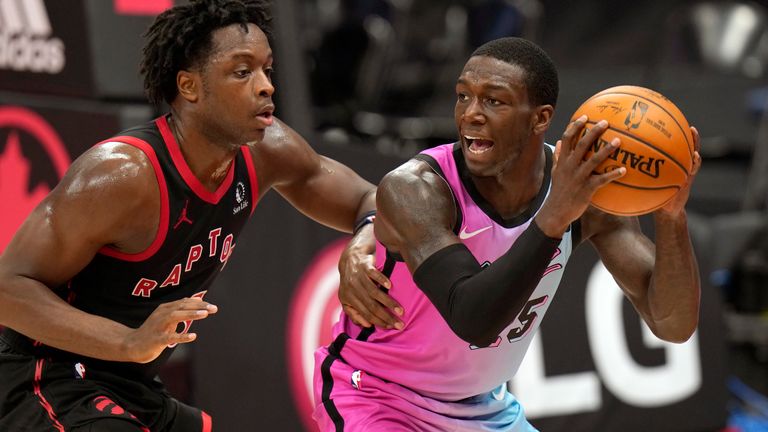 Miami Heat guard Kendrick Nunn (25) looks to pass around Toronto Raptors forward OG Anunoby (3) during the second half of an NBA basketball game Wednesday, Jan. 20, 2021, in Tampa, Fla.