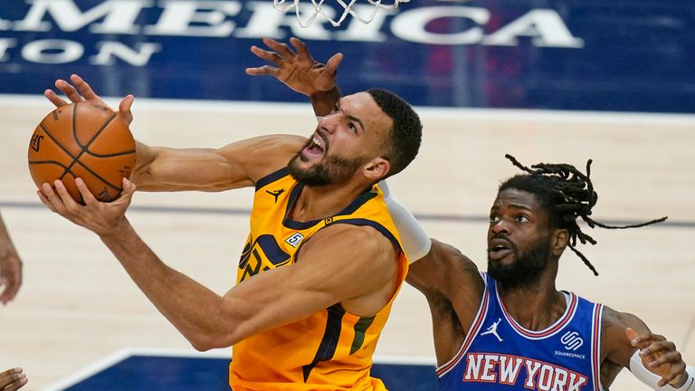 Utah Jazz center Rudy Gobert, left, lays the ball up as New York Knicks center Nerlens Noel (3) defends in the second half during an NBA basketball game Tuesday, Jan. 26, 2021, in Salt Lake City. (AP Photo/Rick Bowmer)


