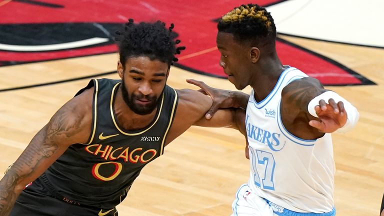 Chicago Bulls guard Coby White, left, drives against Los Angeles Lakers guard Dennis Schroeder during the first half of an NBA basketball game in Chicago, Saturday, Jan. 23, 2021.