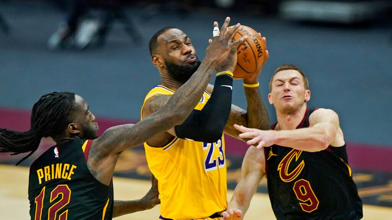 AP - Los Angeles Lakers&#39; LeBron James (23) drives to the basket between Cleveland Cavaliers&#39; Taurean Prince (12) and Dylan Windler (9) in the second half
