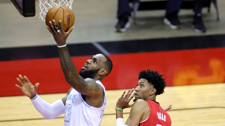 Los Angeles Lakers&#39; LeBron James (23) goes up for a basket ahead of Houston Rockets&#39; Christian Wood (35) during the first quarter of an NBA basketball game Sunday, Jan. 10, 2021, in Houston. (Carmen Mandato/Pool Photo via AP)



