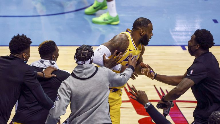 Los Angeles Lakers bench players react after a basket by forward LeBron James against the Houston Rockets during the second quarter of an NBA basketball game Tuesday, Jan. 21, 2021, in Houston. (Troy Taormina/Pool Photo via AP)


