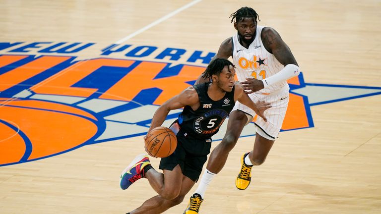 New York Knicks guard Immanuel Quickley (5) drives past Orlando Magic forward James Ennis III (11) during the first half of an NBA basketball game, Monday, Jan. 18, 2021, in New York. (AP Photo/Kathy Willens, Pool)


