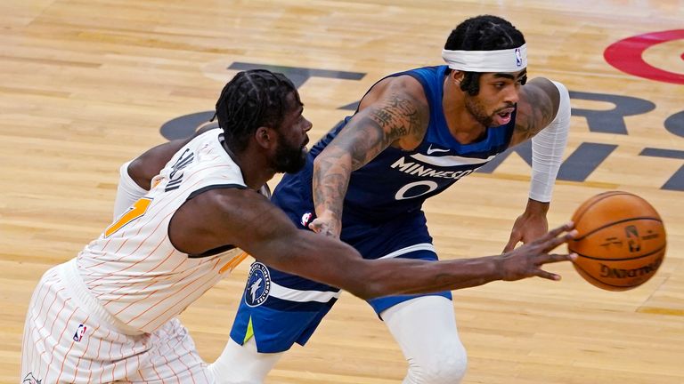 Orlando Magic&#39;s James Ennis III, left, drives as Minnesota Timberwolves&#39; D&#39;Angelo Russell defends during the first half of an NBA basketball game Wednesday, Jan. 20, 2021, in Minneapolis.