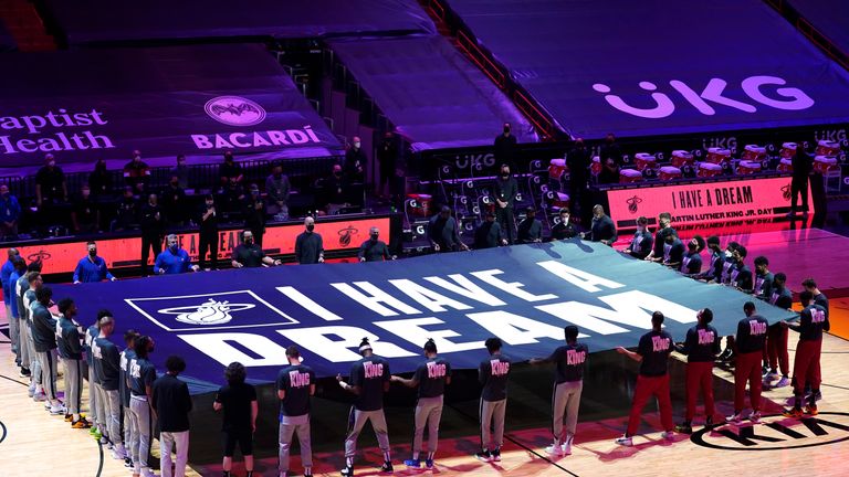 Miami Heat and Detroit Pistons players hold a &#34;I Have a Dream&#34; banner in honor of the Martin Luther King Jr., holiday before an NBA basketball game, Monday, Jan. 18, 2021, in Miami. (AP Photo/Marta Lavandier)


