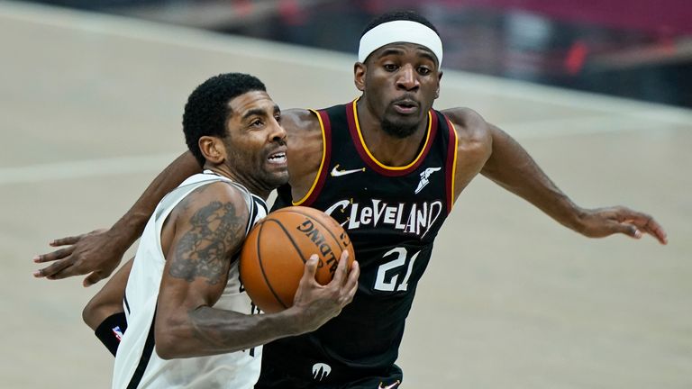 Brooklyn Nets&#39; Kyrie Irving, front, drives to the basket against Cleveland Cavaliers&#39; Damyean Dotson during the second half of an NBA basketball game, Wednesday, Jan. 20, 2021, in Cleveland. The Cavaliers won 147-135 in double-overtime.