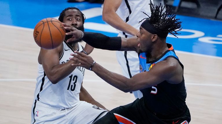 Oklahoma City Thunder forward Luguentz Dort (5) passes the ball in front of Brooklyn Nets guard James Harden (13) during the first half of an NBA basketball game Friday, Jan. 29, 2021, in Oklahoma City. (AP Photo/Sue Ogrocki)


