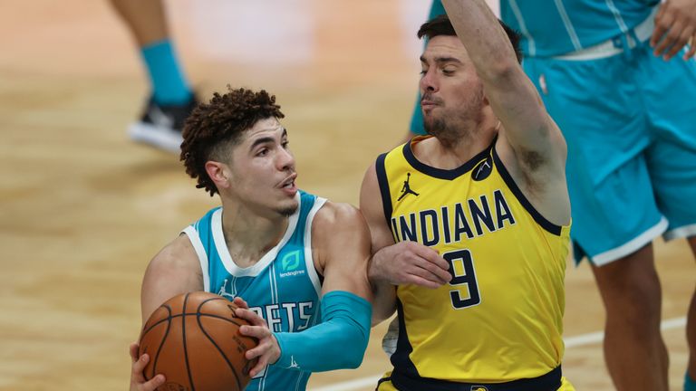 Charlotte Hornets guard LaMelo Ball, left, drives into Indiana Pacers guard T.J. McConnell in the second half of an NBA basketball game in Charlotte, N.C., Friday, Jan. 29, 2021. Charlotte won 108-105. (AP Photo/Nell Redmond)


