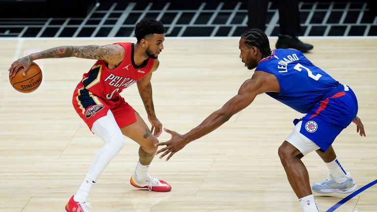 Los Angeles Clippers forward Kawhi Leonard (2) defends against New Orleans Pelicans guard Nickeil Alexander-Walker (6) during the second quarter of an NBA basketball game Wednesday, Jan. 13, 2021, in Los Angeles. (AP Photo/Ashley Landis)


