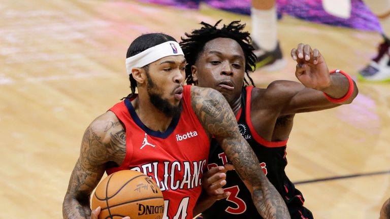 New Orleans Pelicans forward Brandon Ingram (14) drives to the basket as Toronto Raptors forward OG Anunoby (3) defends during the second half of an NBA basketball game on Saturday, Jan. 2, 2021, in New Orleans. (AP Photo/Butch Dill)


