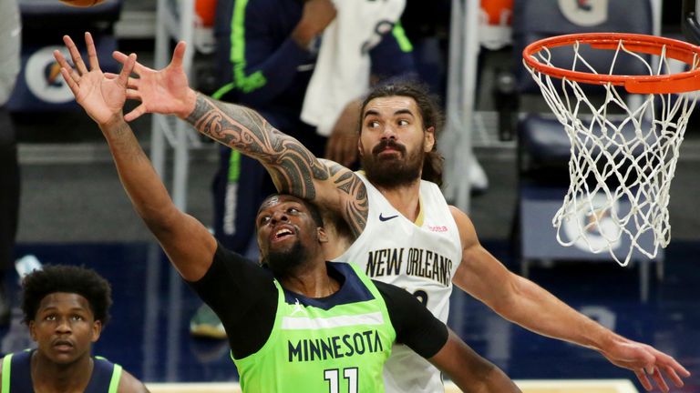 Minnesota Timberwolves center Naz Reid (11) and New Orleans Pelicans center Steven Adams vie for a rebound in the third quarter during an NBA basketball game, Saturday, Jan. 23, 2021, in Minneapolis.