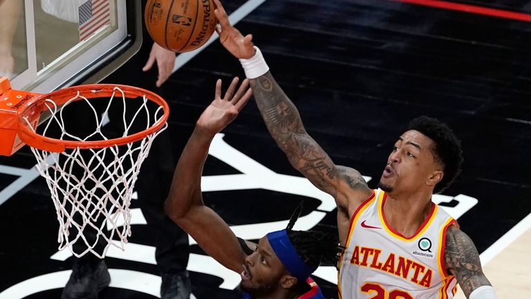Detroit Pistons forward Jerami Grant (9) has his shot blocked by Atlanta Hawks forward John Collins (20) as he drives into Trae Young (11) at the end of the second half of an NBA basketball game Wednesday, Jan. 20, 2021, in Atlanta. The Hawks won 123-115 in overtime.