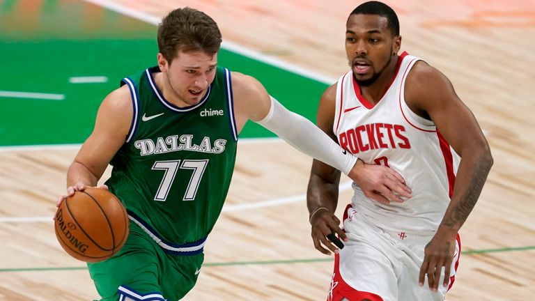 Dallas Mavericks&#39; Luka Doncic (77) drives to the basket as Houston Rockets guard Sterling Brown defends during the first half of an NBA basketball game in Dallas, Saturday, Jan. 23, 2021.