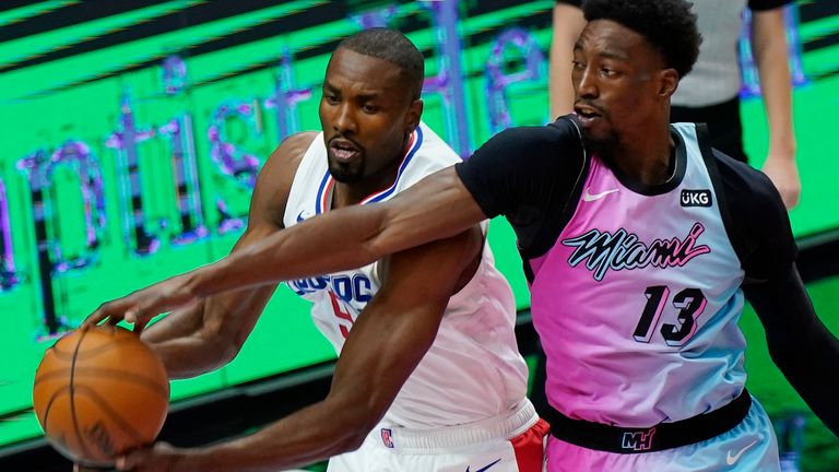 Miami Heat center Bam Adebayo and Los Angeles Clippers center Serge Ibaka battle for a rebound  (AP Photo/Marta Lavandier)