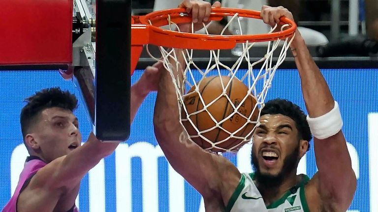 Boston Celtics forward Jayson Tatum (0) dunks the ball as Miami Heat guard Tyler Herro (14) defends during the second half of an NBA basketball game, Wednesday, Jan. 6, 2021, in Miami.