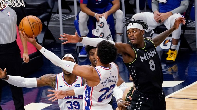 Minnesota Timberwolves&#39; Jarred Vanderbilt (8) tries to block a layup by Philadelphia 76ers&#39; Matisse Thybulle (22) during the first half of an NBA basketball game Friday, Jan. 29, 2021, in Minneapolis. (AP Photo/Jim Mone)


