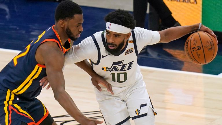 Golden State Warriors forward Andrew Wiggins, left, defends against Utah Jazz guard Mike Conley during the first half during an NBA basketball game Saturday, Jan. 23, 2021, in Salt Lake City.