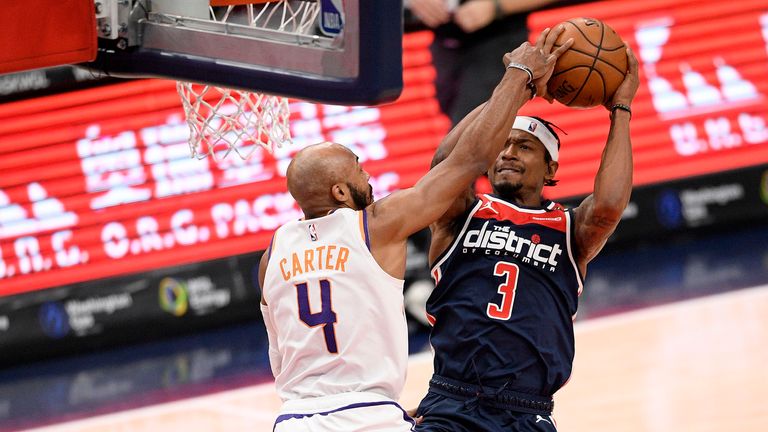 Phoenix Suns guard Jevon Carter (4) fouls Washington Wizards guard Bradley Beal (3) during the second half of an NBA basketball game, Monday, Jan. 11, 2021, in Washington.