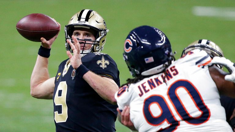 AP - New Orleans Saints quarterback Drew Brees (9) passes under pressure from Chicago Bears defensive tackle John Jenkins (90)