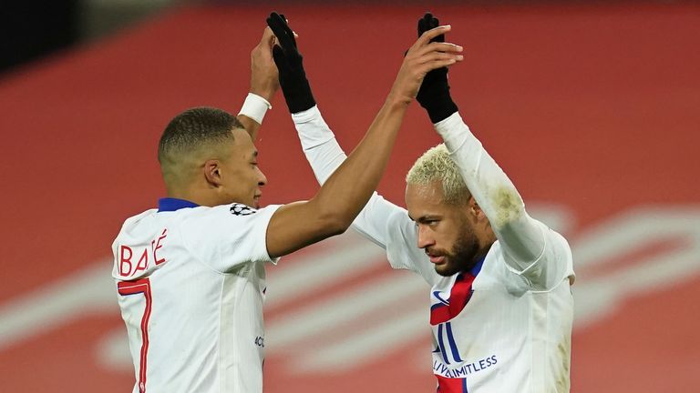 PSG's Neymar, right, celebrates with Kylian Mbappe after scoring his side's third goal during a Group H Champions League soccer match between Manchester United and Paris Saint Germain at the Old Trafford stadium in Manchester, England, Wednesday, Dec. 2, 2020. (AP Photo/Dave Thompson)