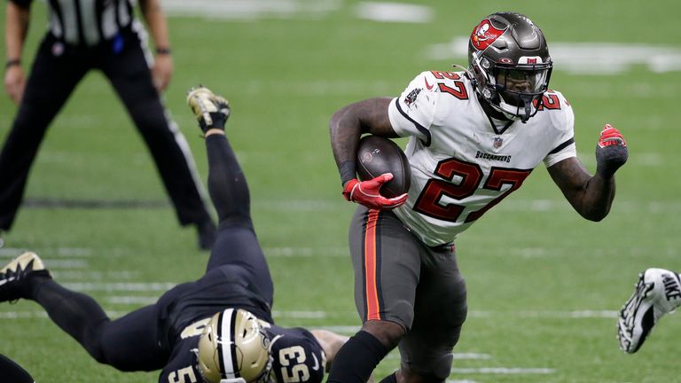 Tampa Bay Buccaneers running back Ronald Jones (27) runs in front of New Orleans Saints outside linebacker Zack Baun (53) during the second half of an NFL divisional round playoff football game, Sunday, Jan. 17, 2021, in New Orleans. (AP Photo/Butch Dill)


