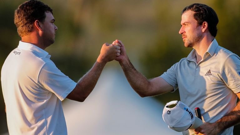 Nick Taylor, right, of Canada, bumps fists with Keith Mitchell at the ninth green during the second round of the Sony Open golf tournament Friday, Jan. 15, 2021, at Waialae Country Club in Honolulu. (AP Photo/Jamm Aquino)