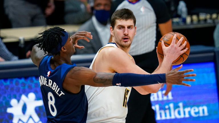 AP - Denver Nuggets center Nikola Jokic, right, looks to pass the ball as Minnesota Timberwolves forward Jarred Vanderbilt 