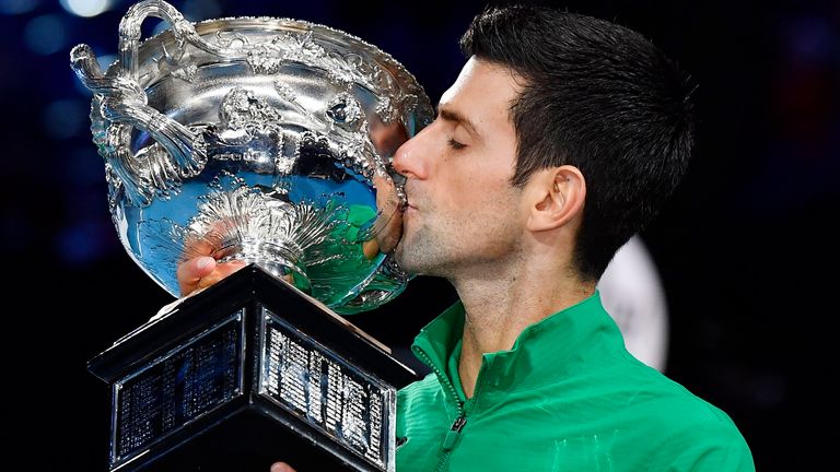 Novak Djokovic of Serbia kisses the trophy after winning the Australian Open tennis tournament in Melbourne on Feb. 2, 2020. (Kyodo via AP Images) 